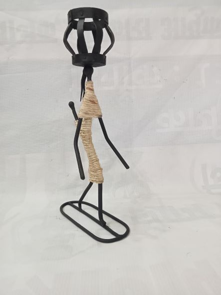 Man holding candle stand on head